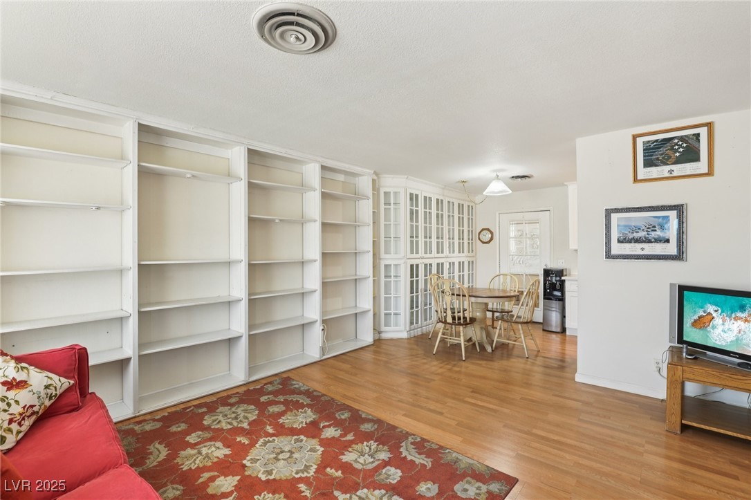 4027 Maple Hill Road Las Vegas, NV 89115 - Photo 7 of 46 Living room featuring wood finished floors and baseboards