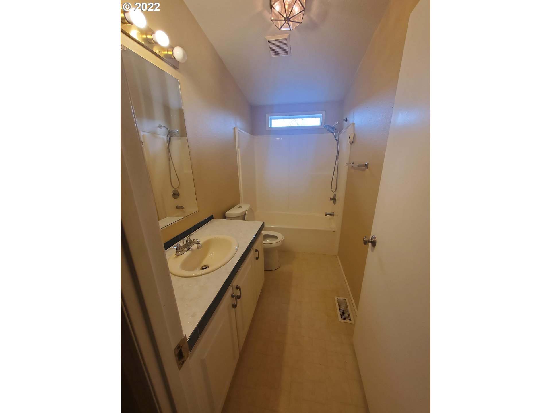 1949 Southeast Palmquist Road, Unit 77 Gresham, OR 97080 - Photo 23 of 30 a bathroom with a sink a mirror and a shower