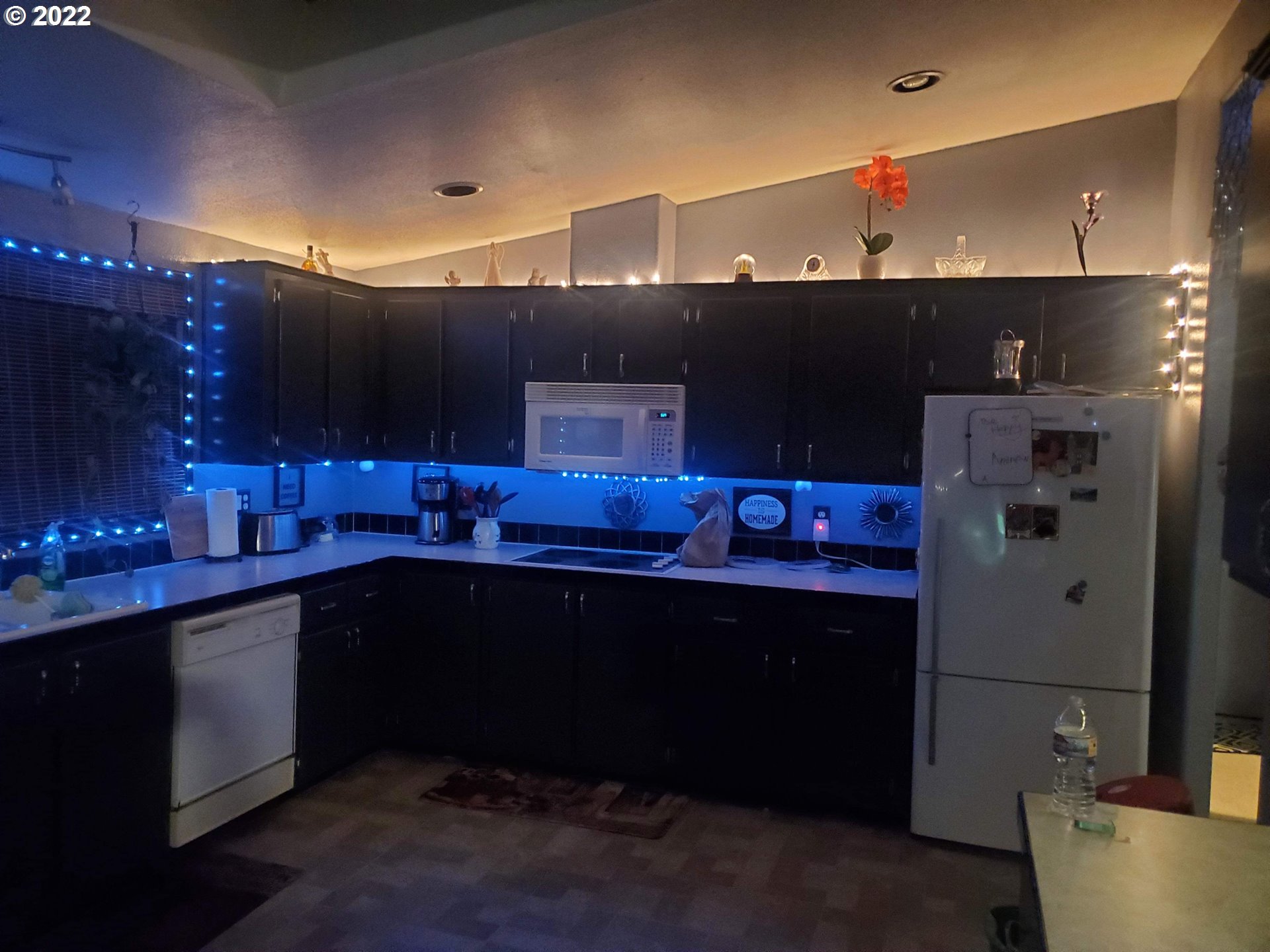 1949 Southeast Palmquist Road, Unit 77 Gresham, OR 97080 - Photo 25 of 30 a kitchen with stainless steel appliances a sink cabinets and wooden floor