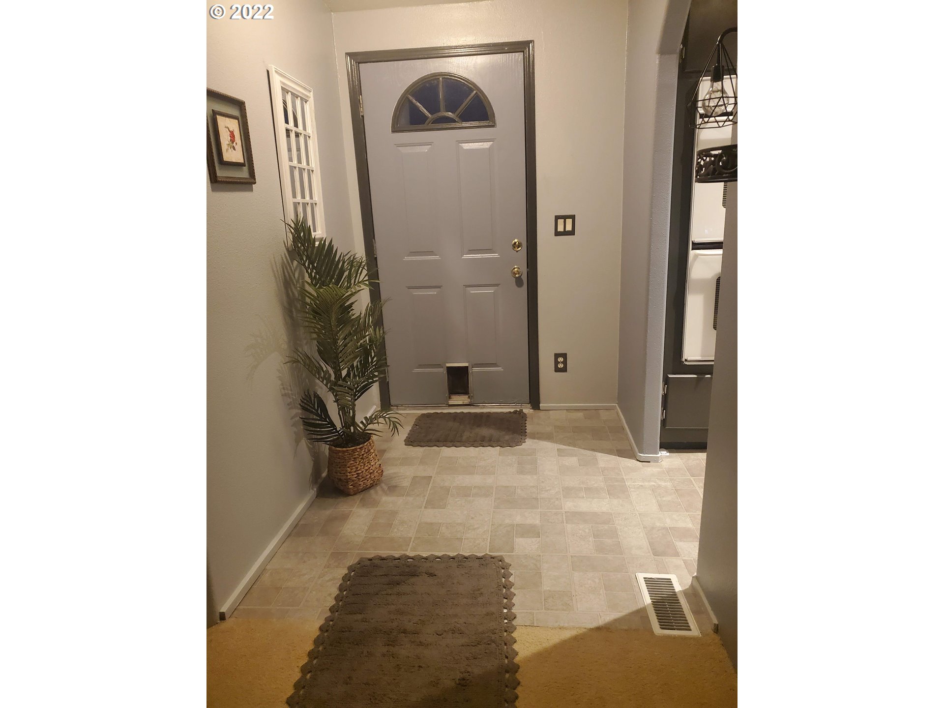 1949 Southeast Palmquist Road, Unit 77 Gresham, OR 97080 - Photo 3 of 30 a view of a hallway with wooden floor