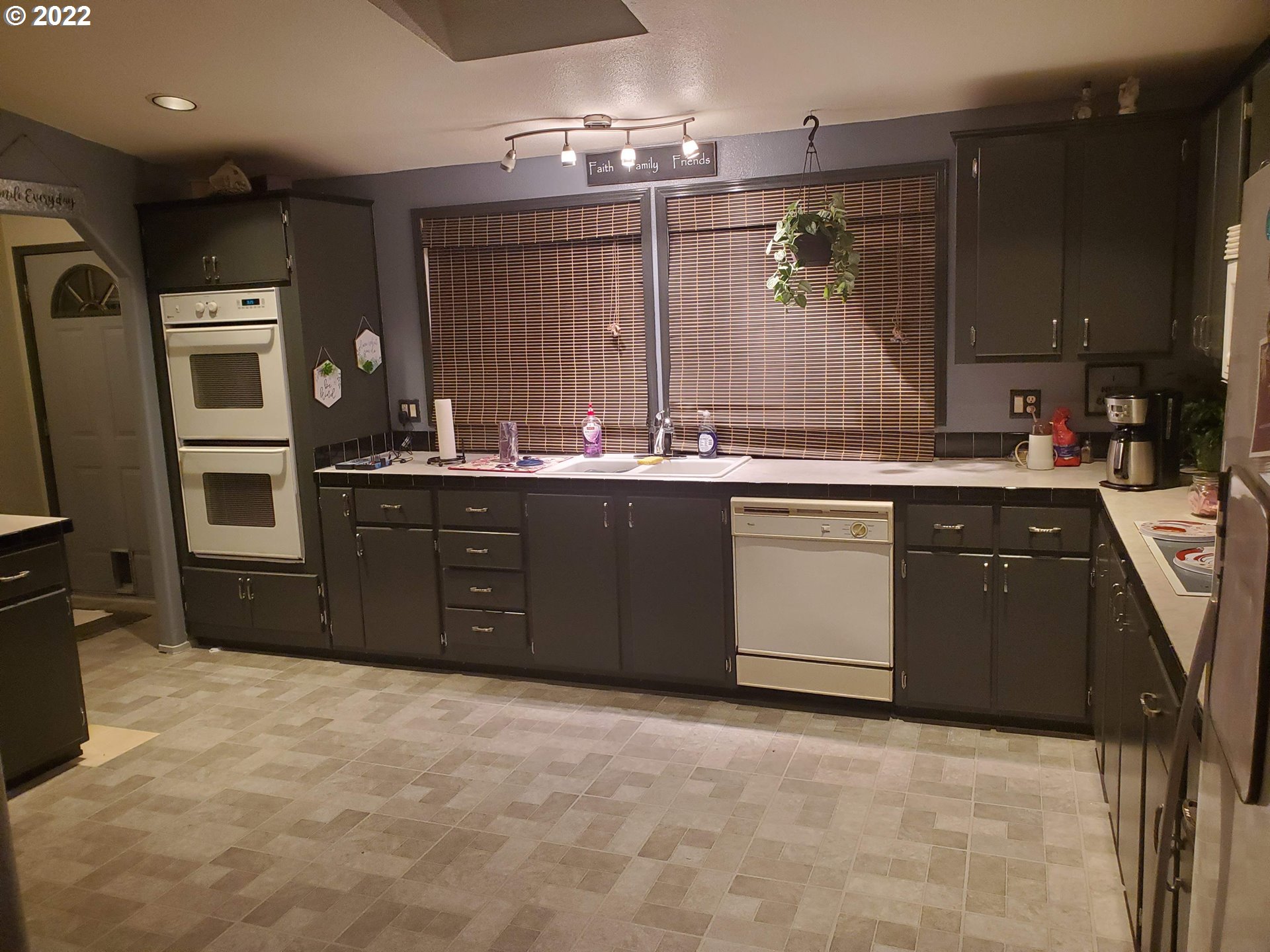 1949 Southeast Palmquist Road, Unit 77 Gresham, OR 97080 - Photo 7 of 30 a kitchen with stainless steel appliances granite countertop a sink stove and refrigerator