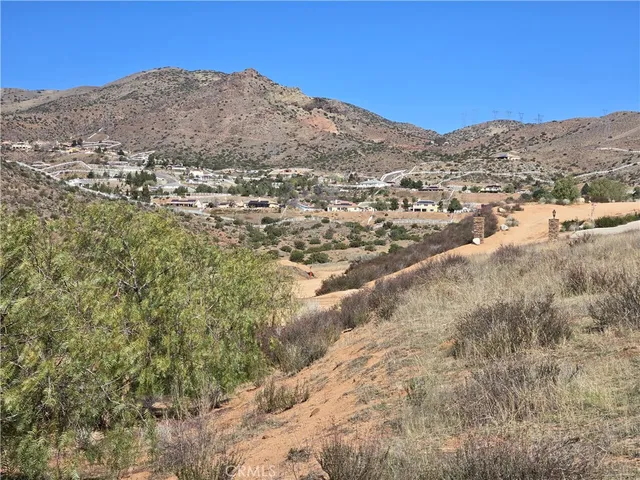 a view of a mountain in the distance in a field