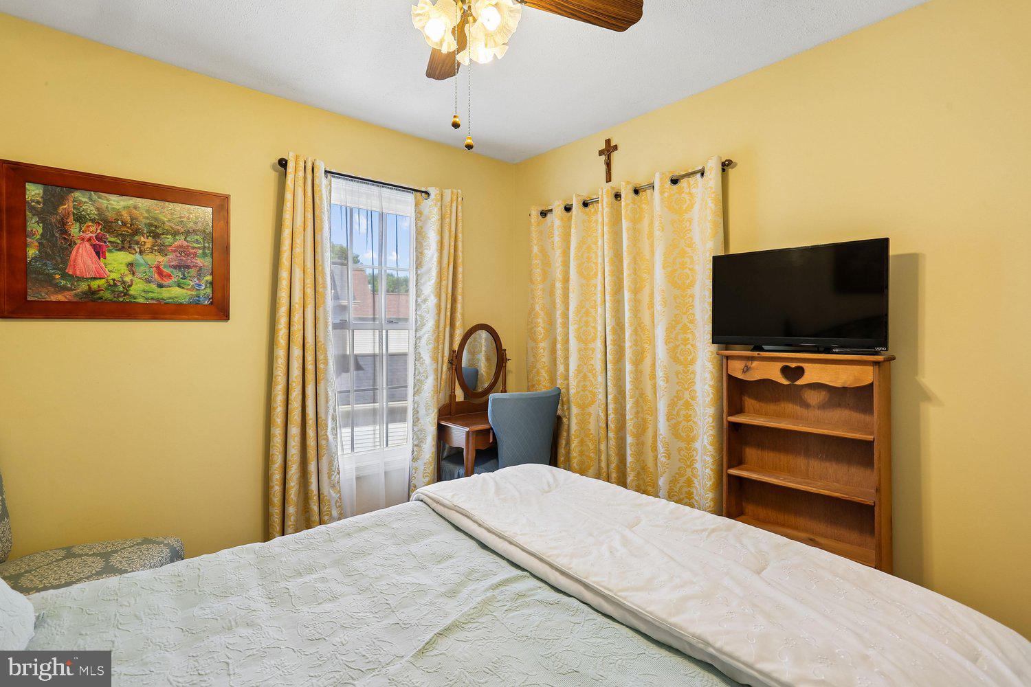 14822 Rose Trellis Place Silver Spring, MD 20906 - Photo 33 of 65 a bedroom with a bed and a flat tv screen on dresser