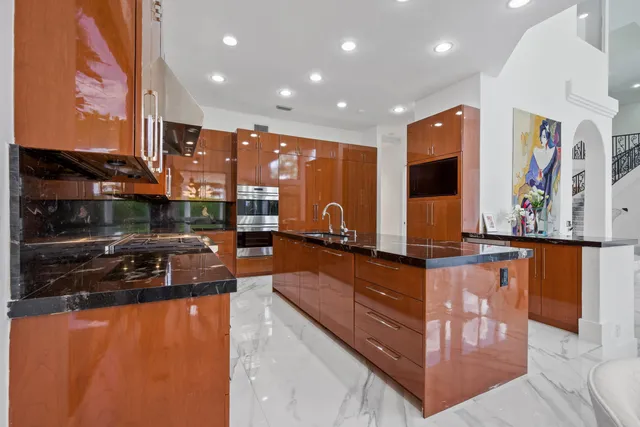 a spacious bedroom with a bed and a chandelier