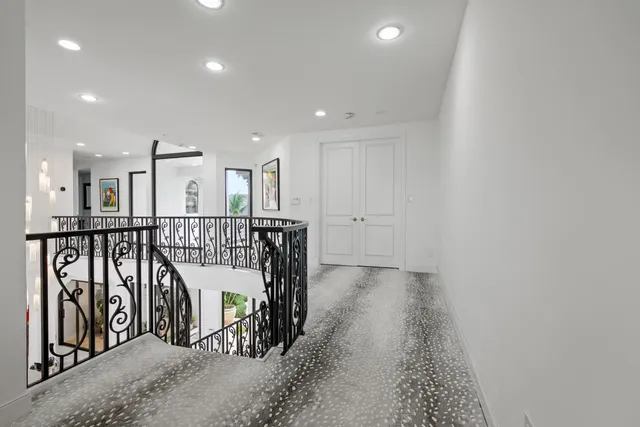 a bedroom with furniture and a large window