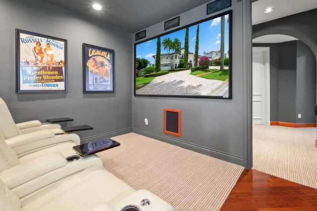 a view of a hallway with wooden floor and a chandelier