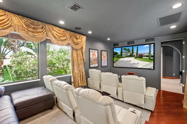 a view of a dining room with furniture large windows and wooden floor