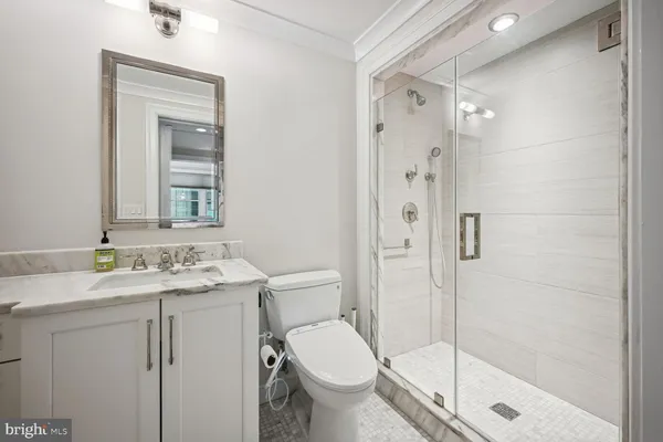 a bathroom with a granite countertop toilet sink and shower
