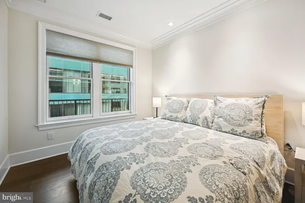 a large bed sitting in a bedroom next to a window