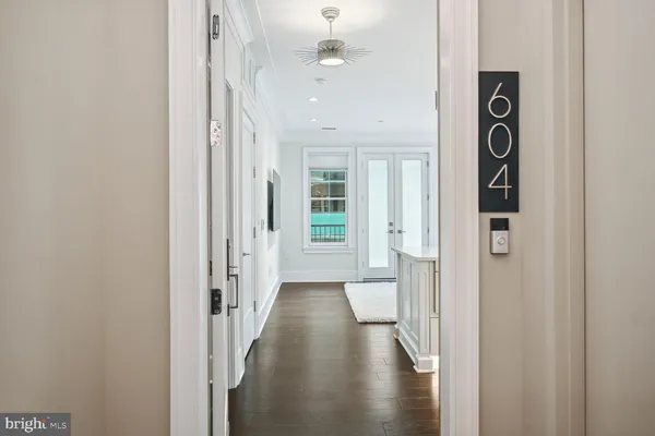 a view of a hallway with wooden floor and entryway