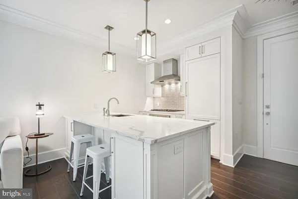 a view of a center island and wooden floor