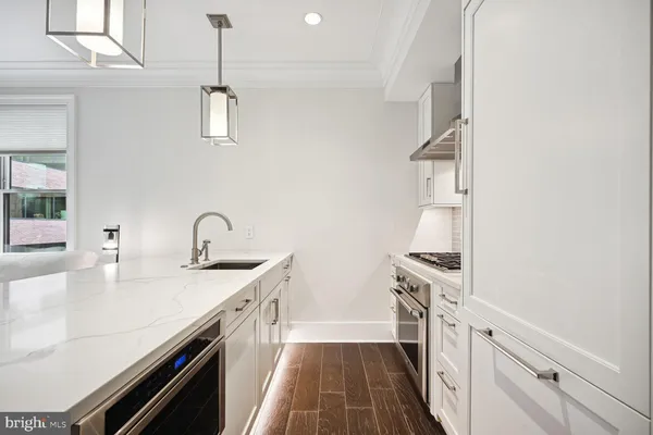 a kitchen with a sink stove and cabinets