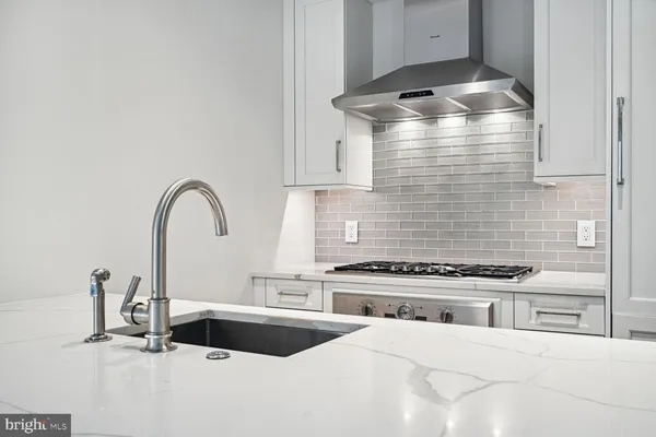 a kitchen with a stove and a sink