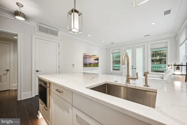 a kitchen with a sink and a stove top oven