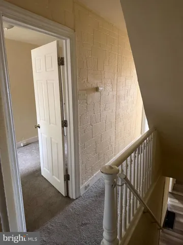 a view of a hallway with wooden floor and entryway