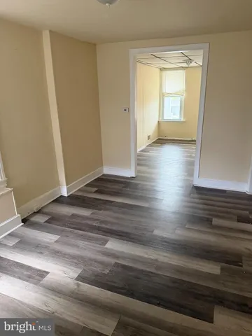 a view of wooden floor and windows in a room
