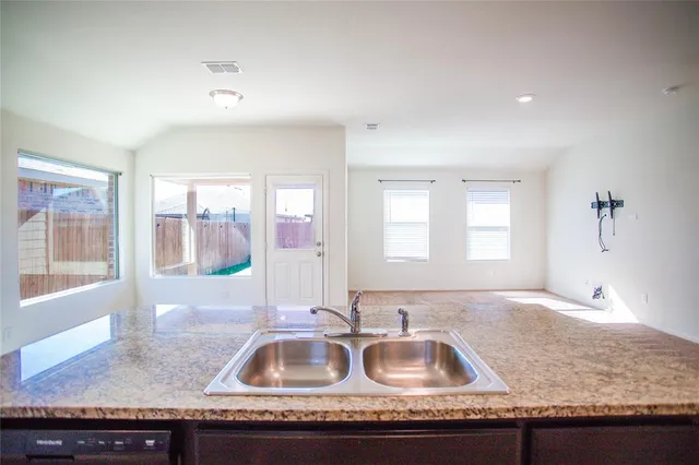 a kitchen with granite countertop a sink and a granite counter tops