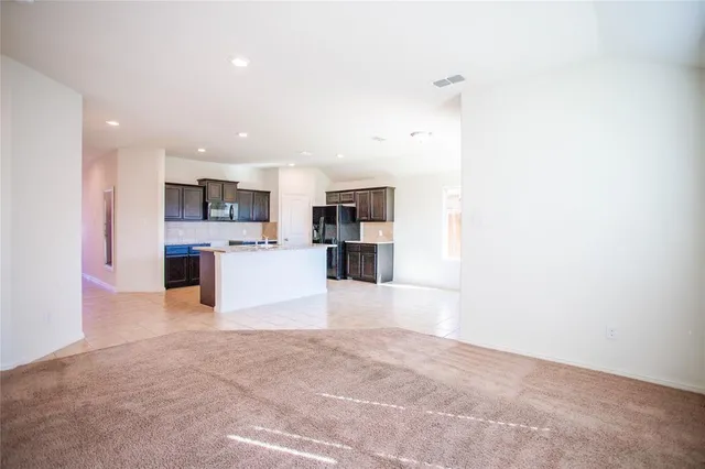 a view of a kitchen with a sink and a refrigerator