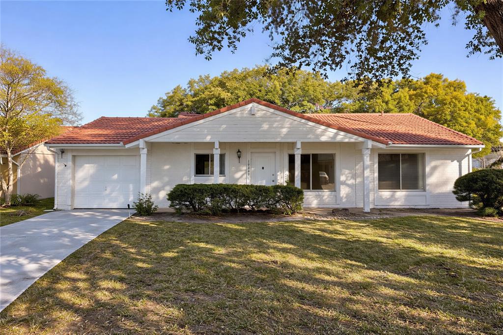 a front view of a house with a garden and porch