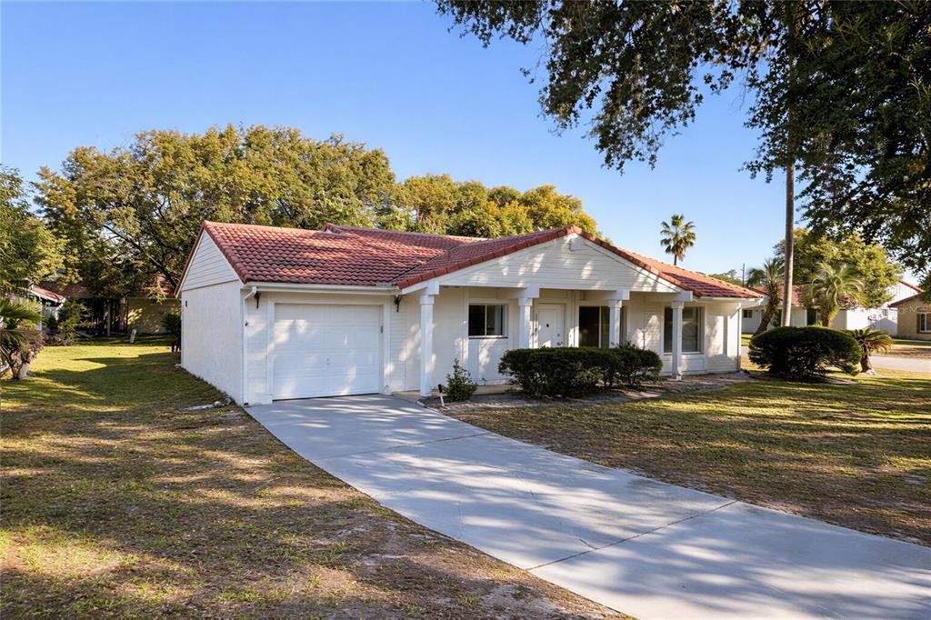 10849 Wheaton Court Orlando, FL 32821 - Photo 2 of 16 a front view of a house with a yard