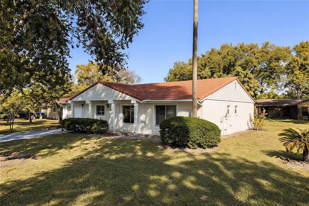 10849 Wheaton Court Orlando, FL 32821 - Photo 3 of 16 a front view of a house with a yard