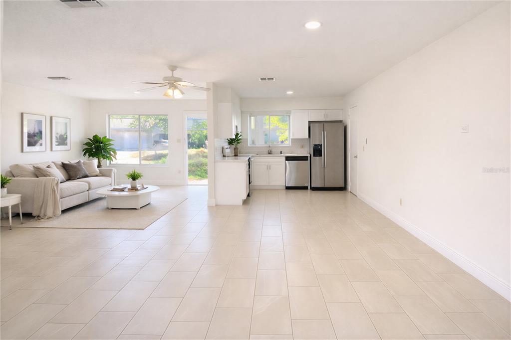 10849 Wheaton Court Orlando, FL 32821 - Photo 8 of 16 a living room with furniture and a large window