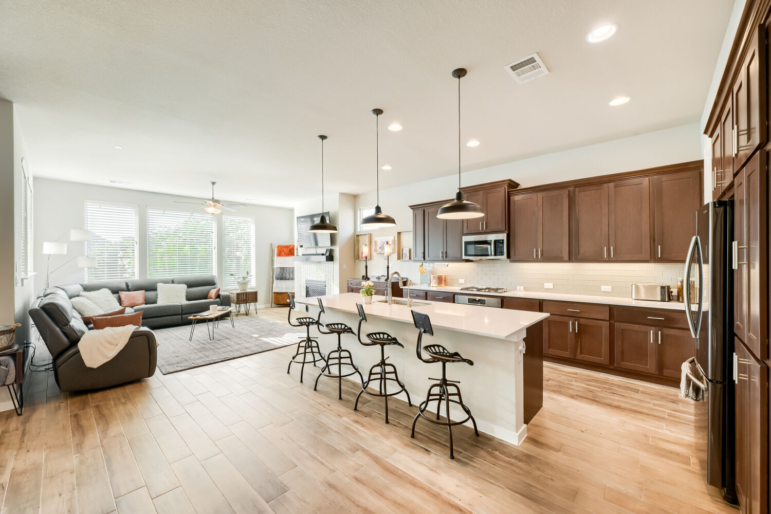 621 Rancho Sienna Loop Georgetown, TX 78628 - Photo 27 of 28 An open concept floorplan seamlessly connects the kitchen and living areas, bathed in natural light.