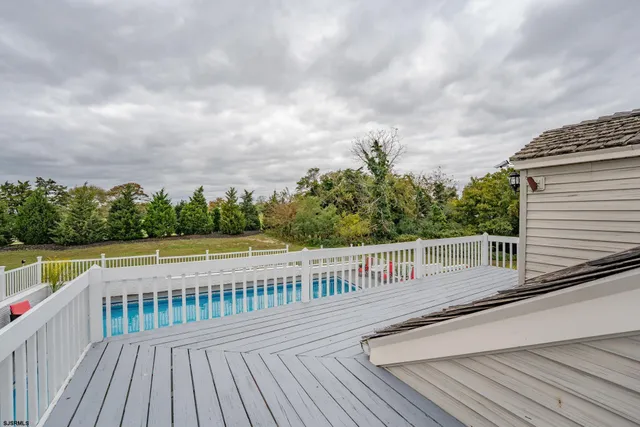 a spacious bathroom with a granite countertop sink a toilet and a mirror