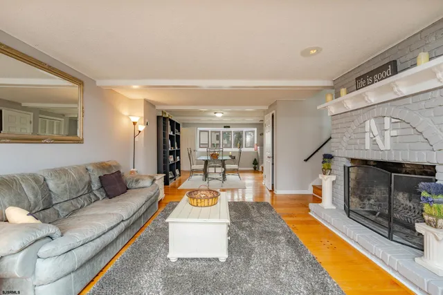 a dining room with furniture and wooden floor