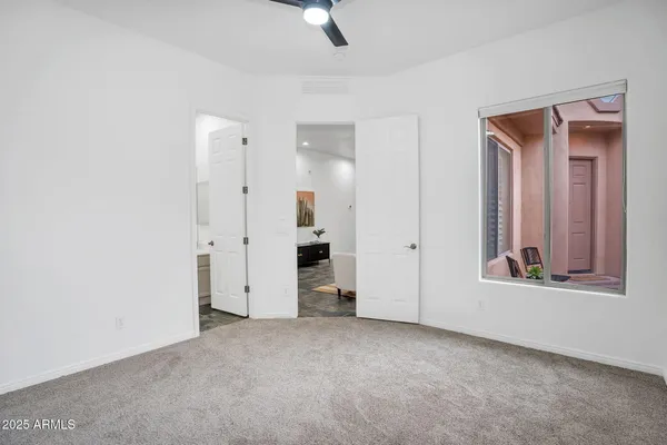 an empty room with windows and closet