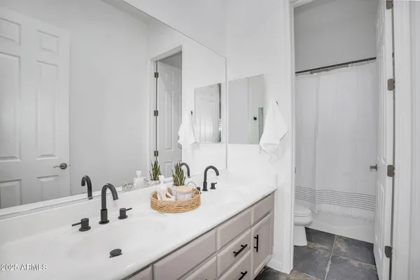 a bathroom with a sink double vanity and a tub