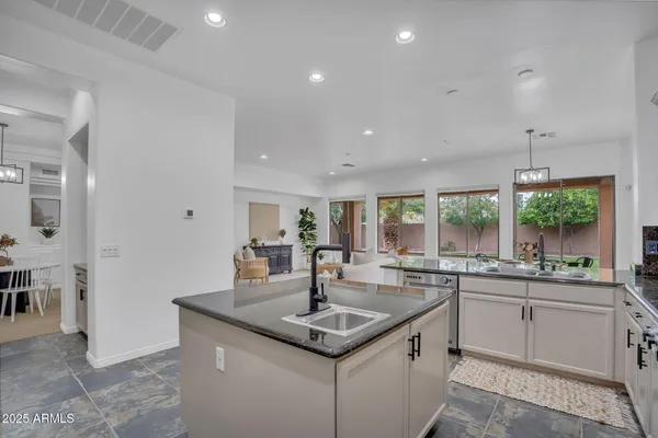 a kitchen with sink stove and cabinets