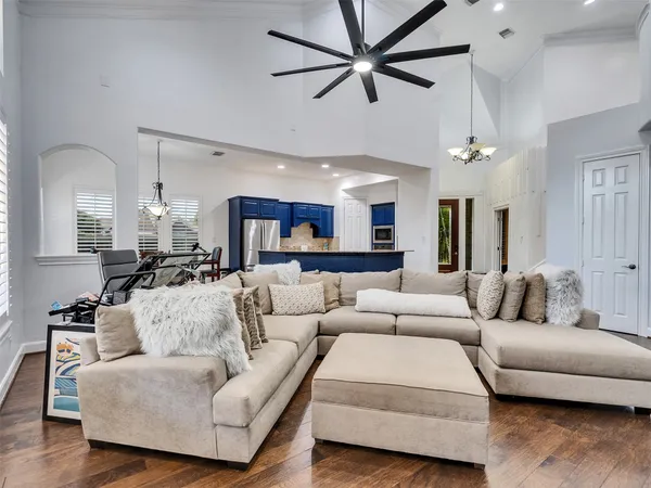 a living room with furniture and a ceiling fan