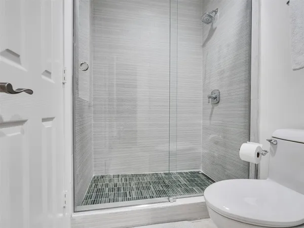 a bathroom with a toilet and a shower