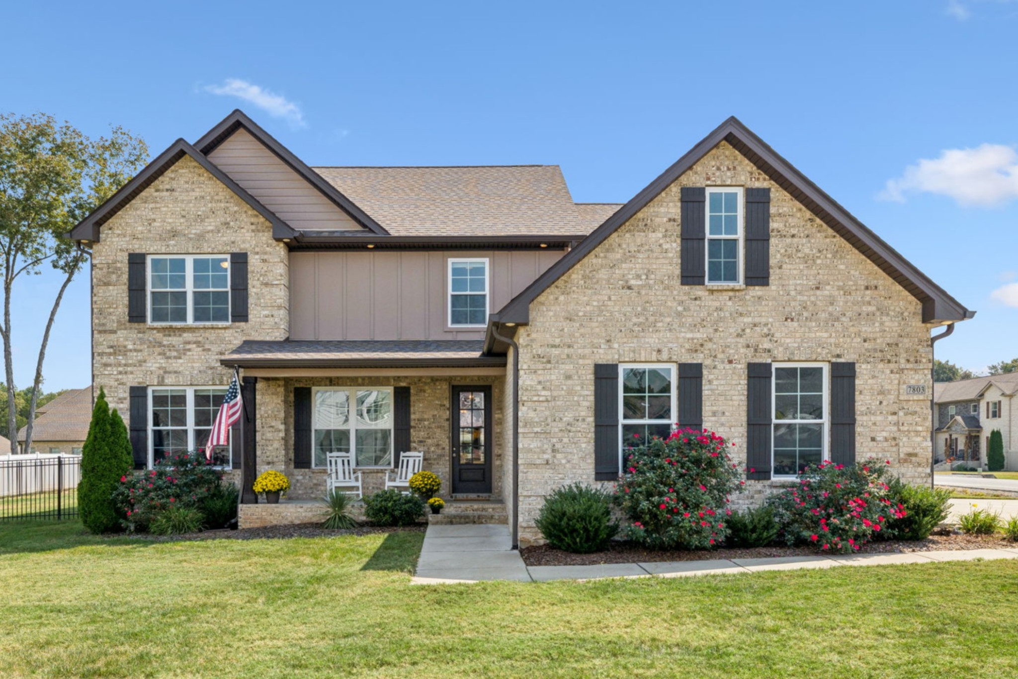 a front view of a house with a yard and porch