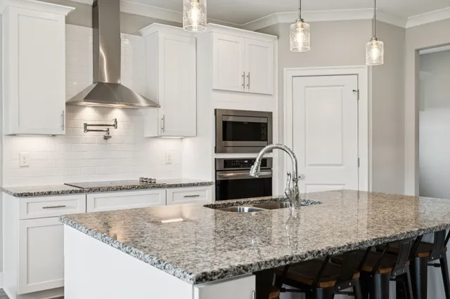 a dining room with furniture a chandelier and wooden floor