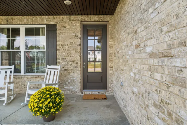 a view of a livingroom with wooden floor and windows