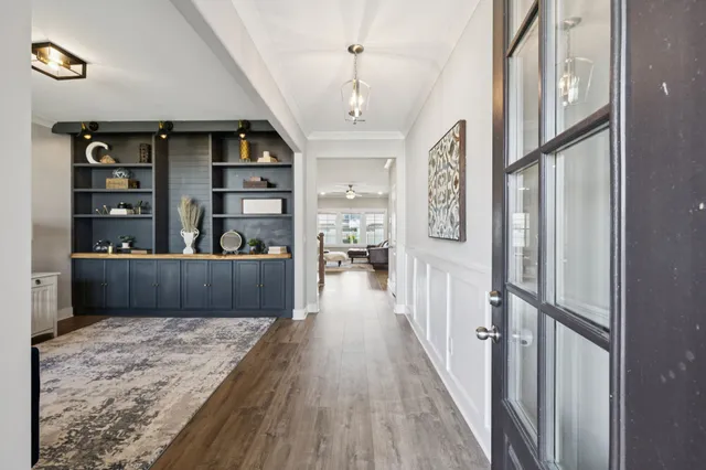a living room with furniture cabinets and window