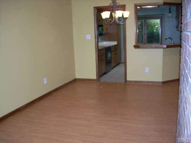 4339 Sunscape Lane Raleigh, NC 27613 - Photo 2 of 10 Dining room has new beautiful hardwood look laminate flooring as does living room and hall. Other