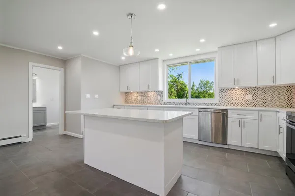 a view of a kitchen with a sink and a large window