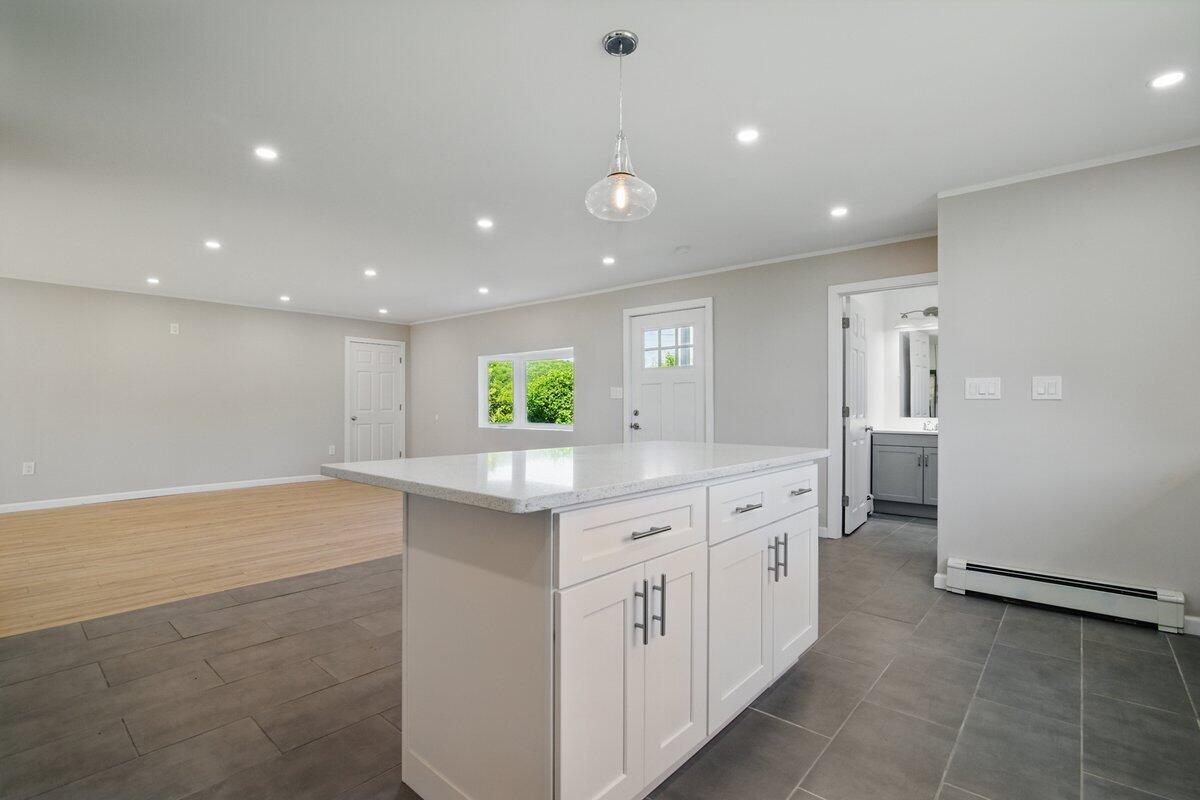1652 Bonser Road Saylorsburg, PA 18353 - Photo 13 of 62 a large kitchen with stainless steel appliances a large counter top a stove and a refrigerator