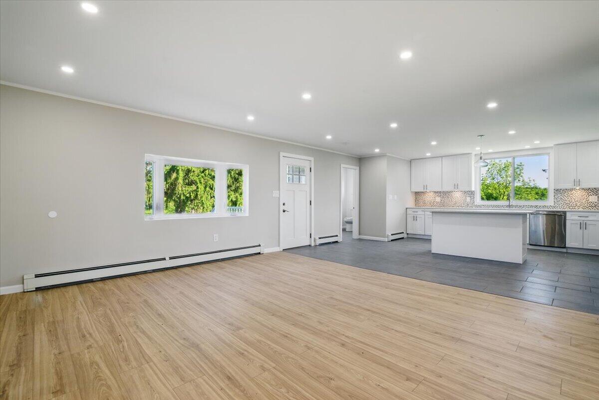 1652 Bonser Road Saylorsburg, PA 18353 - Photo 62 of 62 a view of an empty room with wooden floor and a kitchen