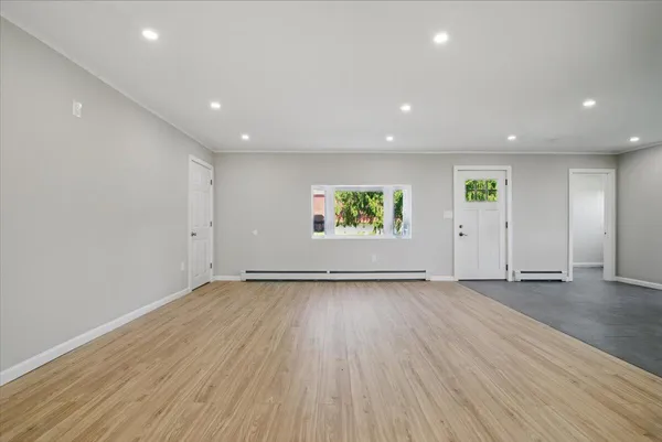 wooden floor in an empty room with a window