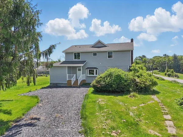 a front view of a house with a yard