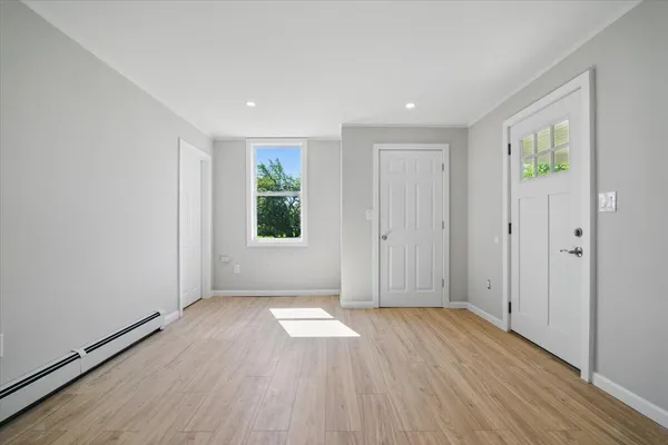 a view of a hallway view with wooden floor and staircase