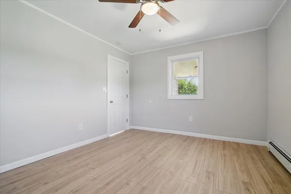 a view of empty room with wooden floor
