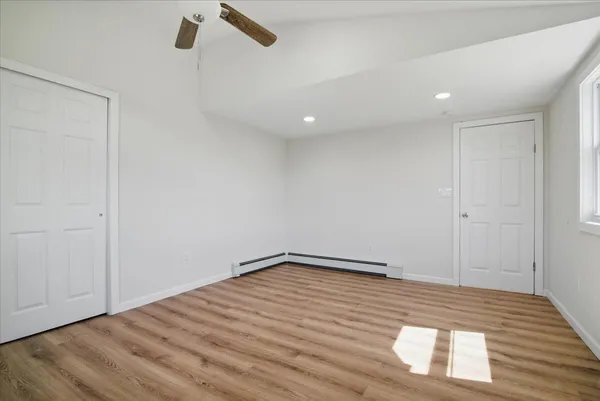 wooden floor in an empty room with a window