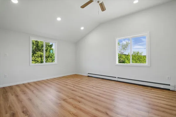 a view of empty room with wooden floor