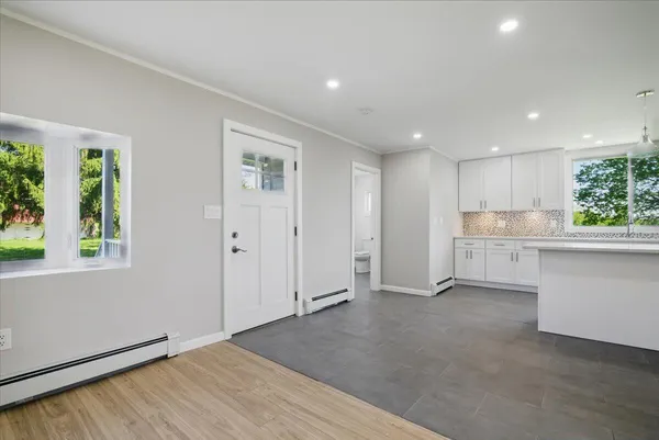 a kitchen with a refrigerator sink and cabinets