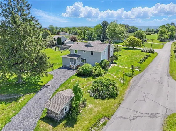 an aerial view of a house with a yard basket ball court and outdoor seating